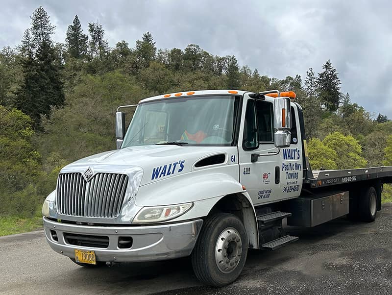 A photo of a Walt's Towing flat bed tow truck